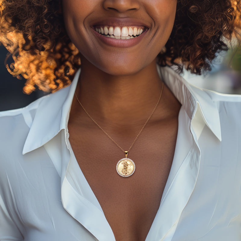 Round gold-tone coin pendant necklace with rhinestone halo on chain