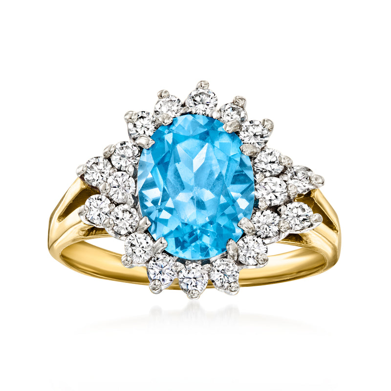 14kt yellow gold ring with oval Swiss-blue topaz center and diamond halo