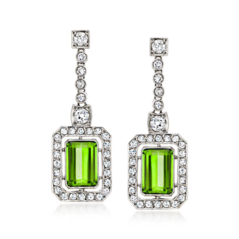 Platinum drop earrings with green square gemstone and diamond halo accents