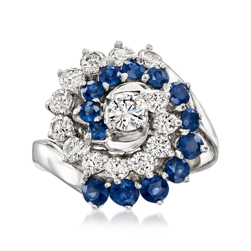 14kt white gold swirl ring with blue sapphires and round diamonds, cluster setting