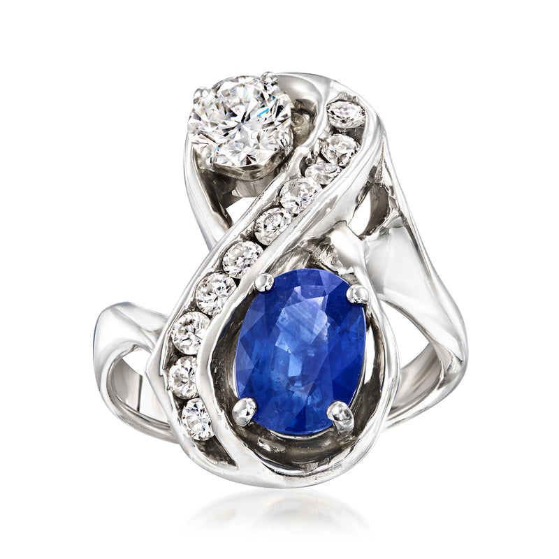 Vintage white gold ring with oval blue sapphire and diamond clusters