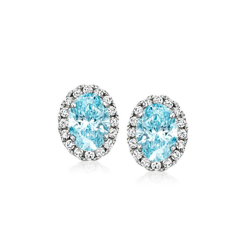 Oval blue diamond stud earrings with white diamond halo and post backs