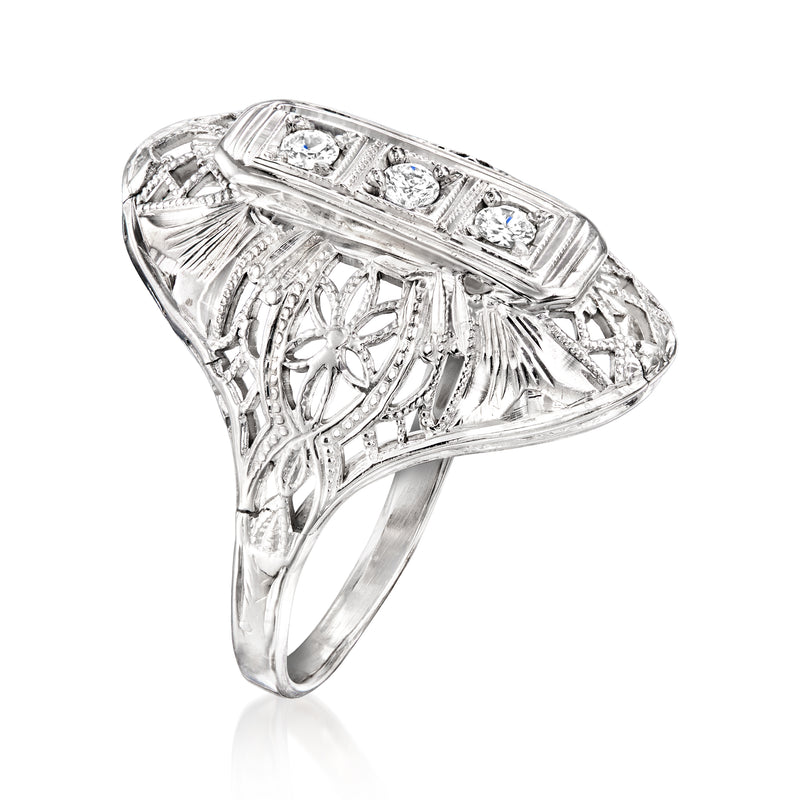 Diamond filigree ring with side scrollwork and rectangular row of round stones