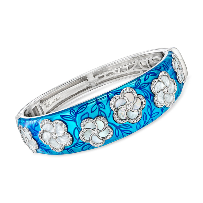 Sterling silver bangle bracelet with blue enamel and four white floral stone motifs