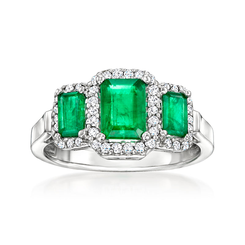 14kt white gold three-stone ring with emerald-cut green center and diamond accents