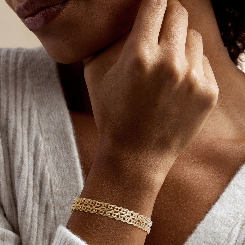 Gold over sterling two-row link bracelet worn on wrist, round clasp visible