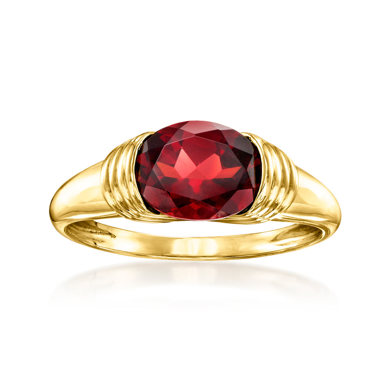 14kt yellow gold ring with oval red garnet centerpiece and twisted metal shoulders