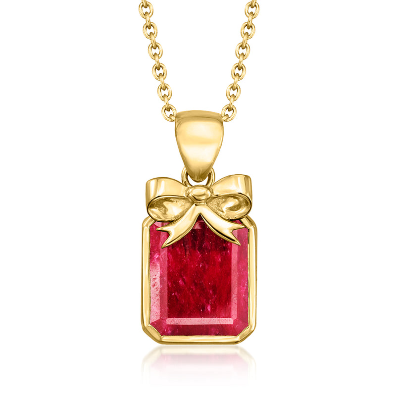 Gold bow pendant necklace with red ruby-style gemstone set in a bezel
