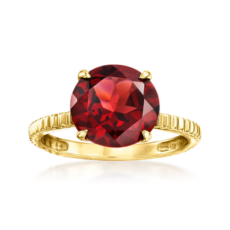Yellow gold ring with oval red garnet center and four prongs, smooth band