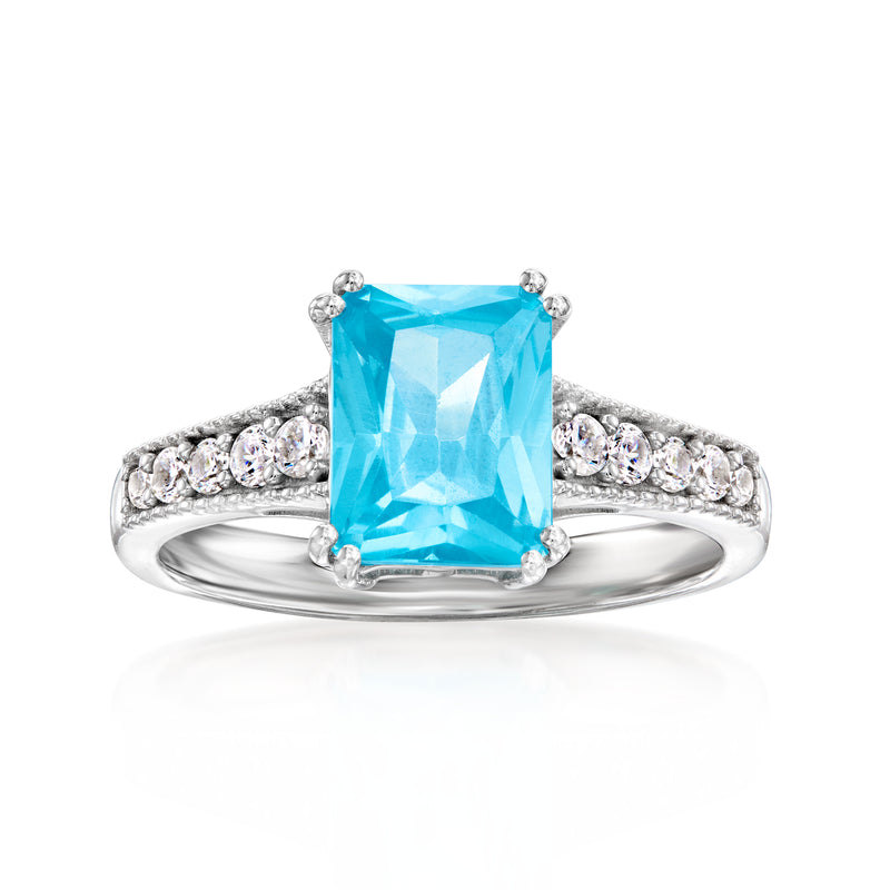 Sterling silver ring with simulated Swiss blue topaz center and CZ halo and bands