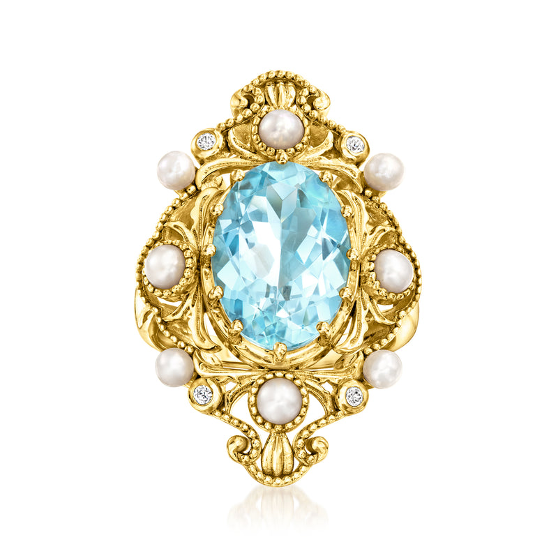 Gold-tone ring with oval sky-blue gemstone, white pearls, and small clear stones