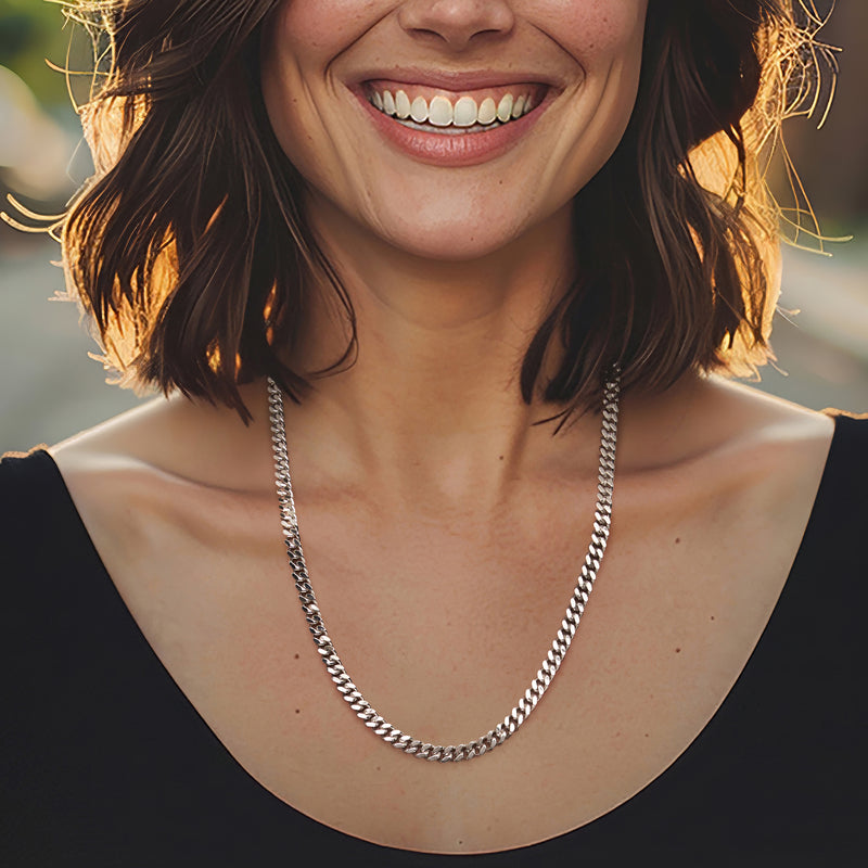 Sterling silver Cuban-link chain necklace worn close to the neckline