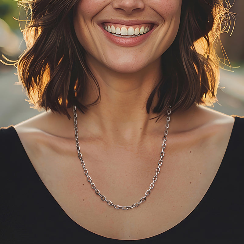 Sterling silver cable-link necklace worn on the neckline, polished links