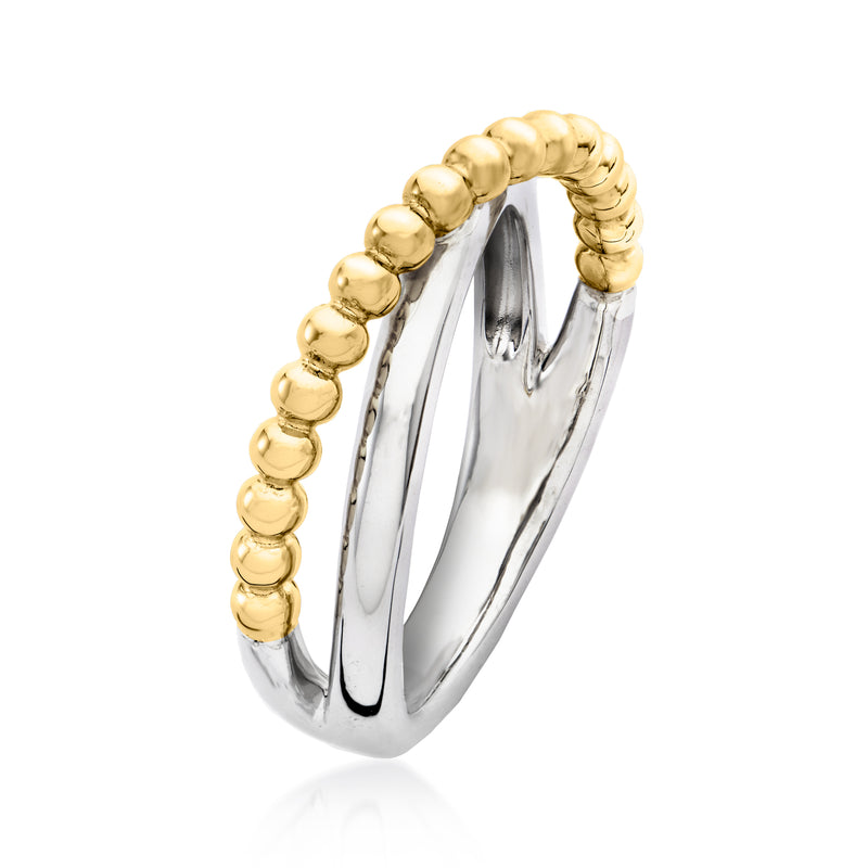 Crisscross ring angled view with yellow gold bead edge over gleaming silver interior