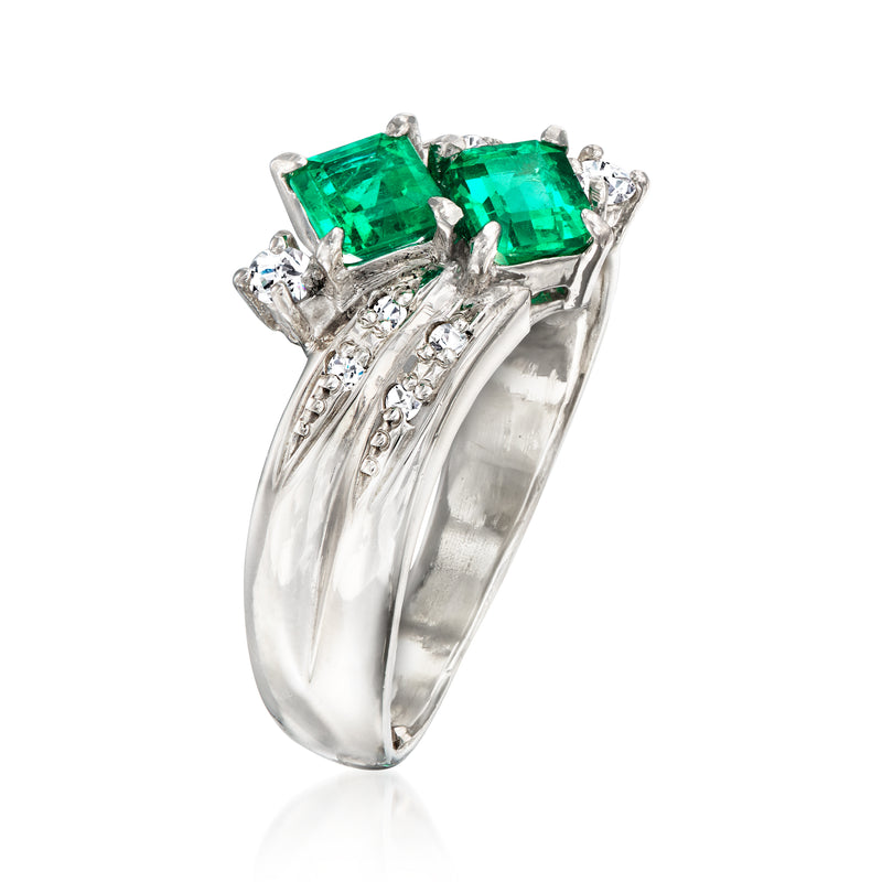 Platinum vintage ring with emerald-cut green stones and diamond side accents, side view