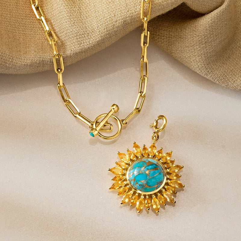 Gold toggle necklace with turquoise sunflower pendant and yellow petal border