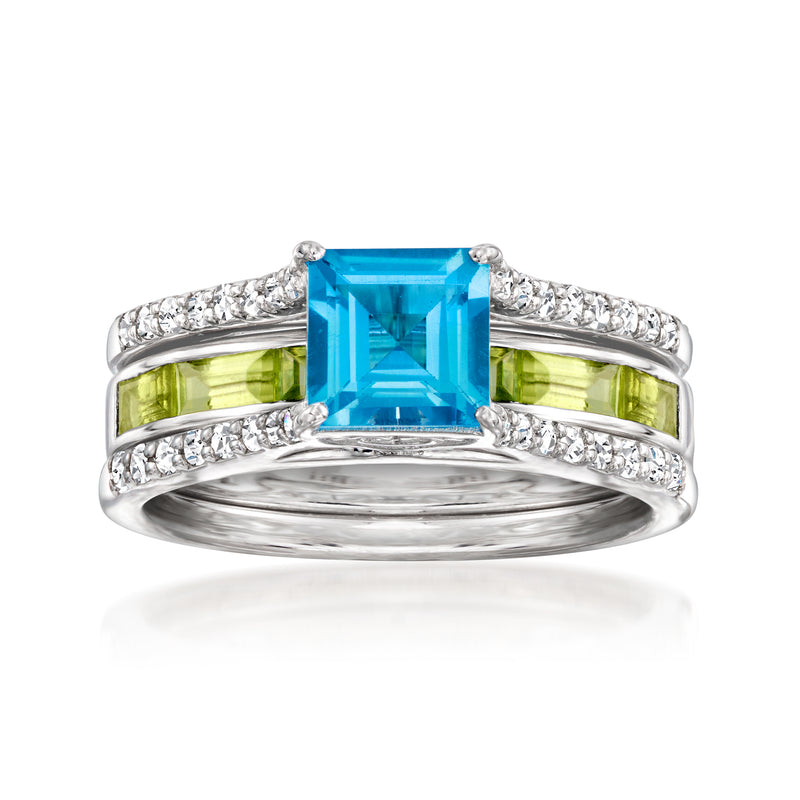 Sterling silver ring with blue topaz center, peridot side stones, and white topaz accents