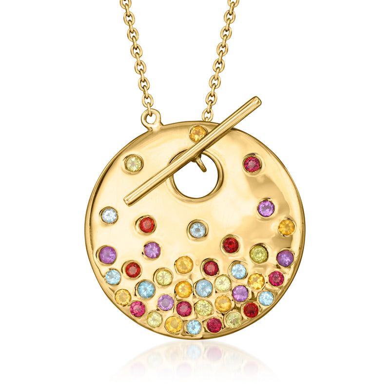 Round gold-tone toggle necklace pendant with scattered multicolor gemstones and bar toggle