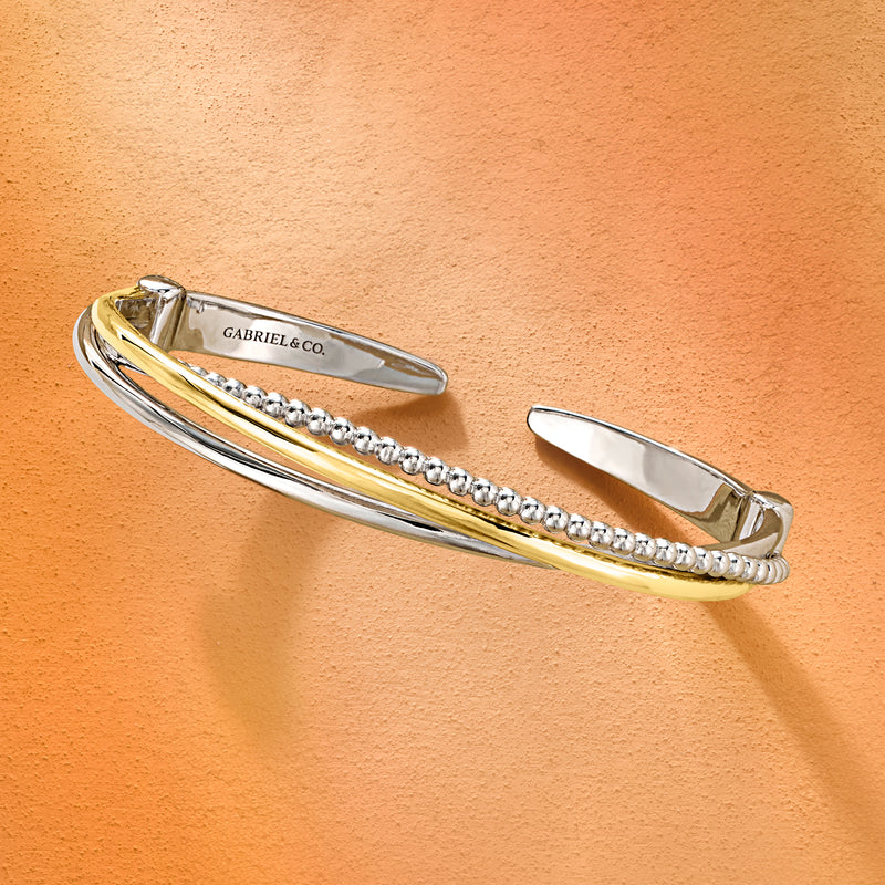 Sterling silver cuff bracelet with yellow gold twist stripe and row of silver bead details