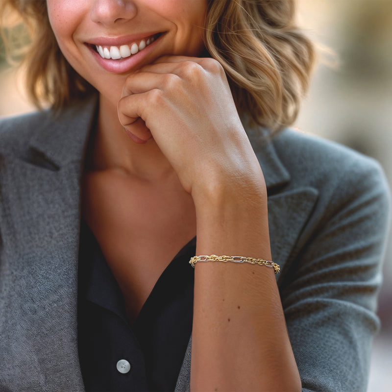 Two-tone rope-chain bracelet in gold and silver worn on wrist