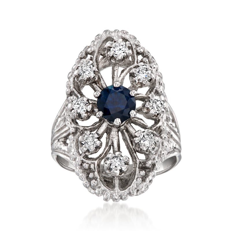 Vintage white gold ring with blue sapphire center and diamond filigree halo