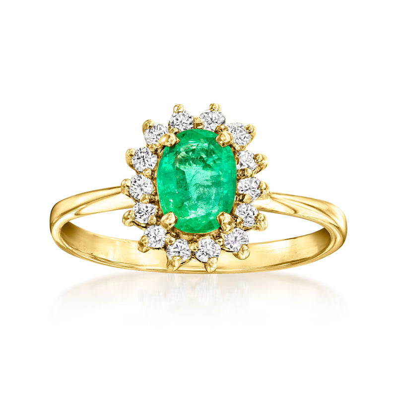Vintage oval emerald centerpiece ring in 14kt yellow gold with diamond halo and side stones