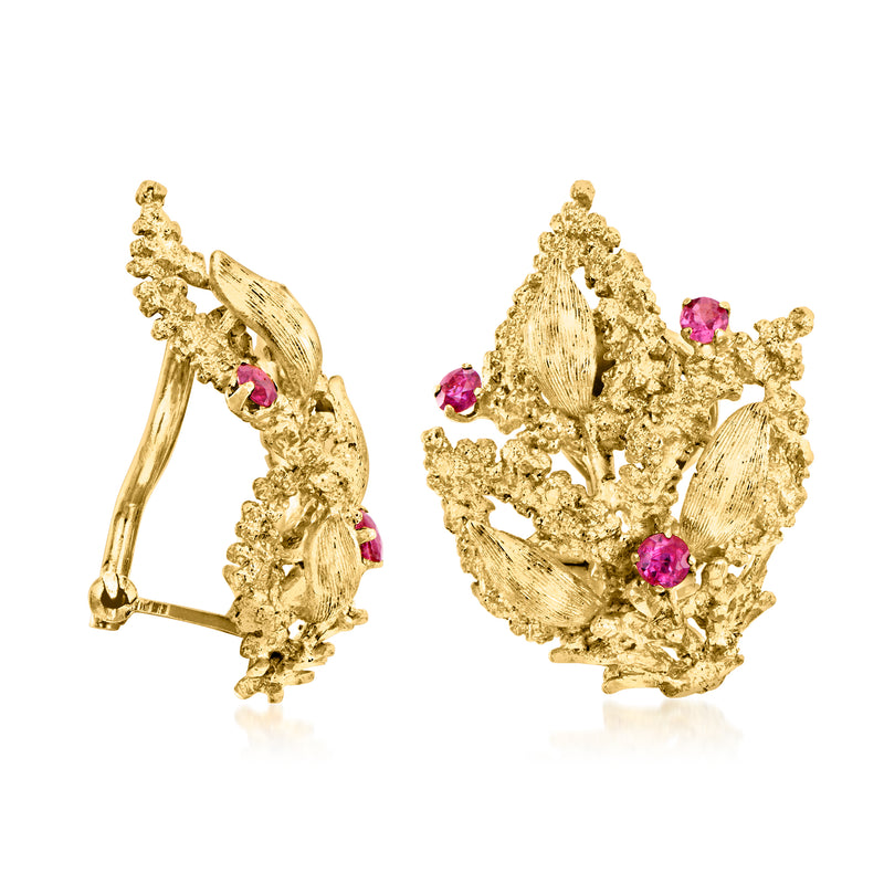 Gold floral clip-on earrings with pink ruby-like accents, side view