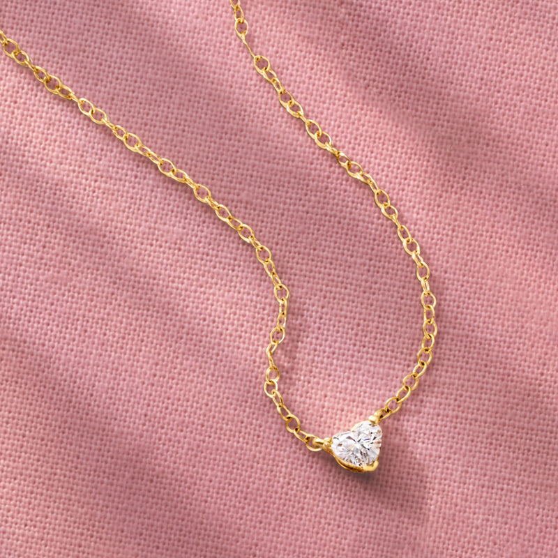 Close-up heart-shaped lab-grown diamond solitaire necklace on 14kt yellow gold chain
