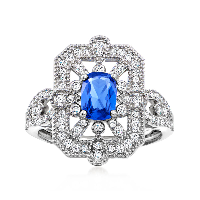 Sterling silver halo ring with oval blue simulated sapphire and clear CZ accents