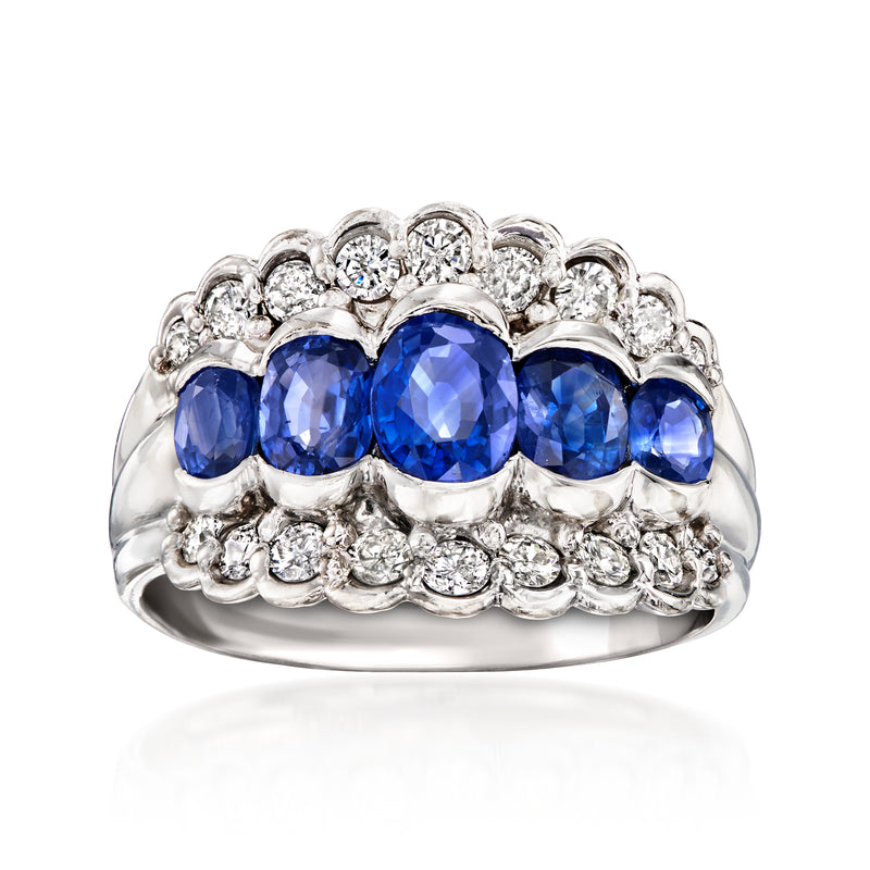 Scalloped platinum ring with oval blue sapphires and diamond clustered detailing