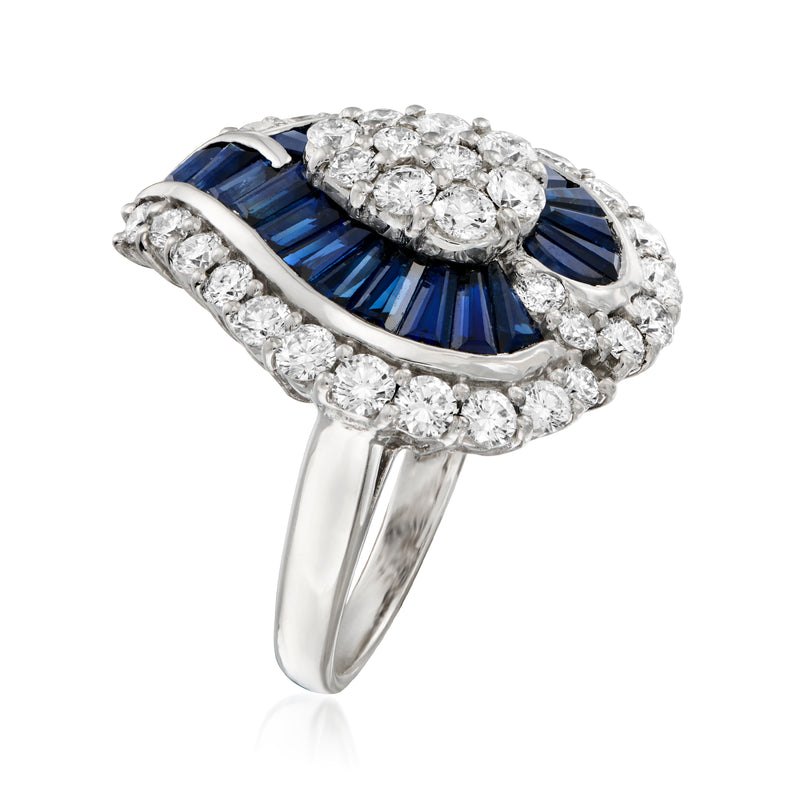Platinum sapphire and diamond cluster ring viewed at angle with blue center stone