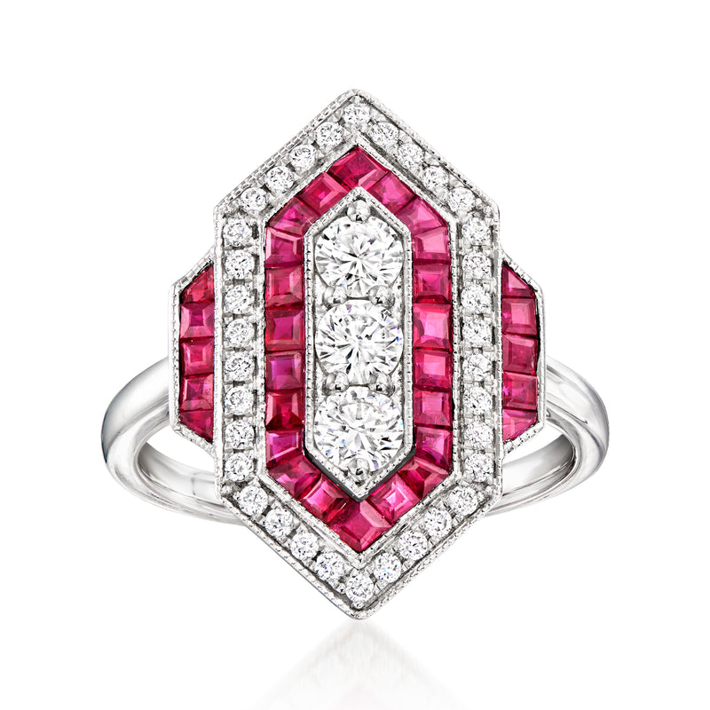 Platinum ring with elongated diamond center, pink ruby side stones, and diamond frame