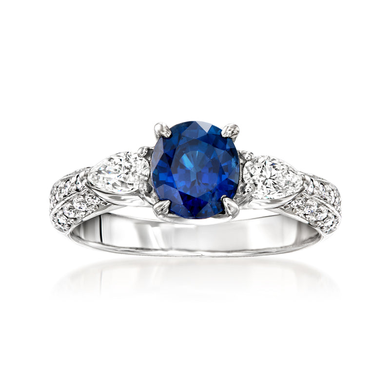 Platinum ring with oval blue sapphire center and diamond accents on curved shoulders