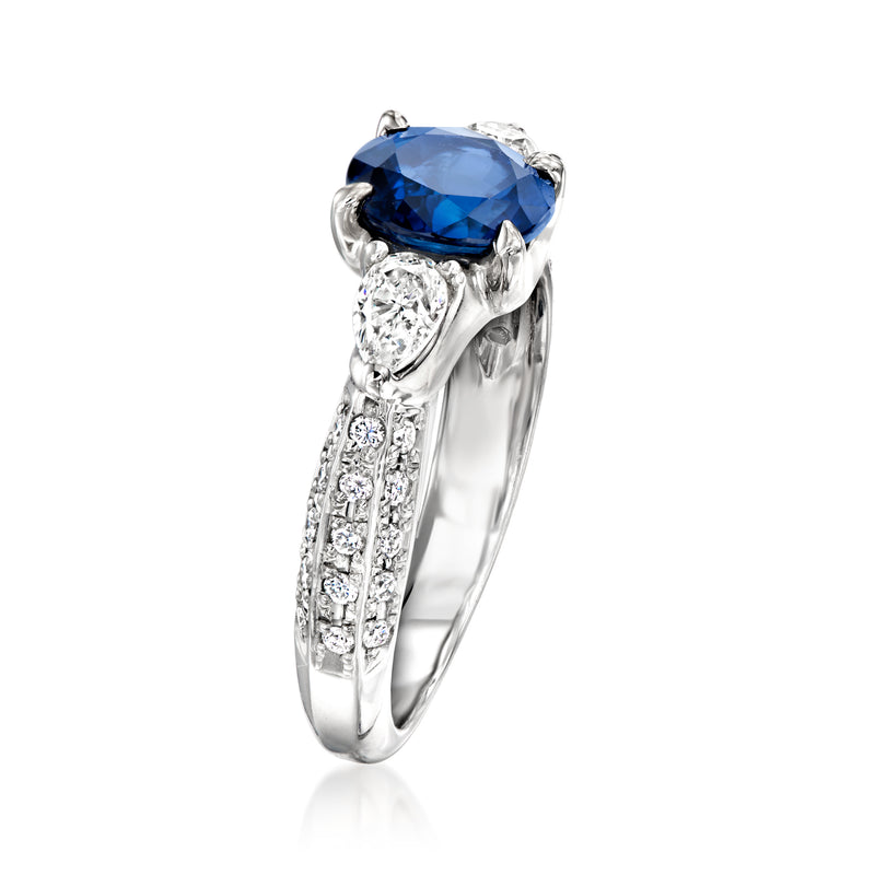Platinum ring with large oval blue sapphire and diamond details along the band
