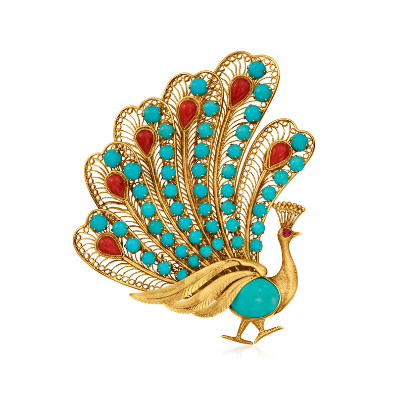 Gold-tone peacock pin with turquoise and red coral accents, single ruby center