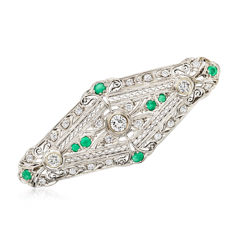 Platinum filigree oval pin with round diamond and green emerald stones