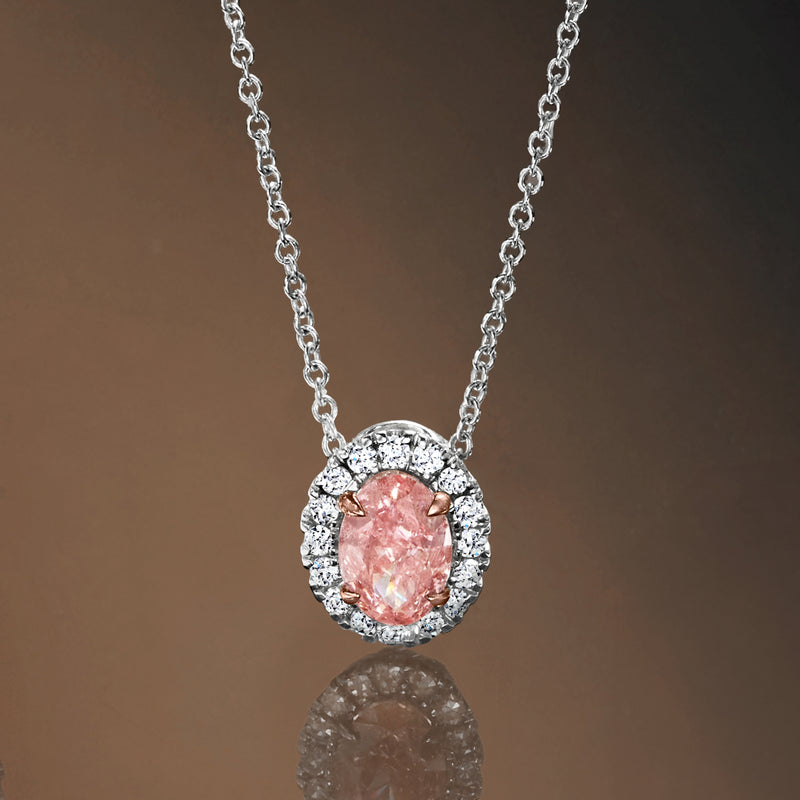 Pink diamond pendant in white diamond halo with 14kt white gold chain, close-up
