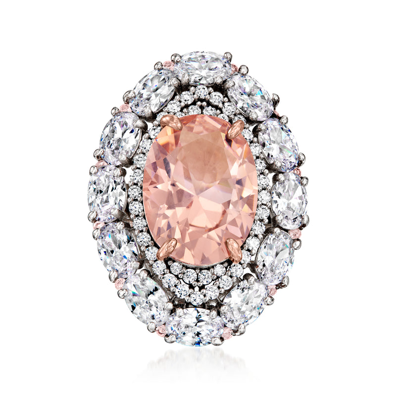 Sterling silver ring with oval peach center stone, clear CZ halo and rose gold prongs