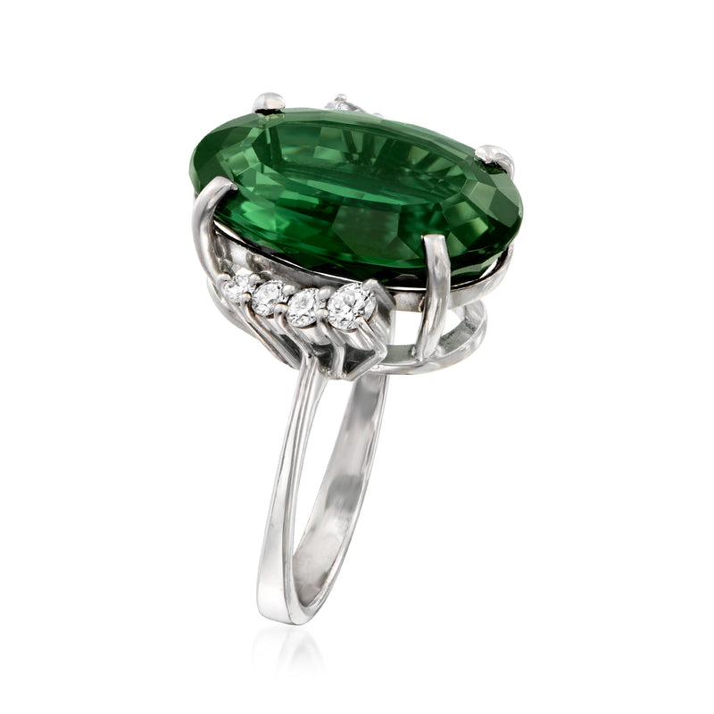 Oval green tourmaline ring with prong setting and diamond halo band in white gold