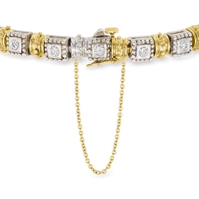 Two-tone gold diamond bracelet close-up with linked center and small drop charms