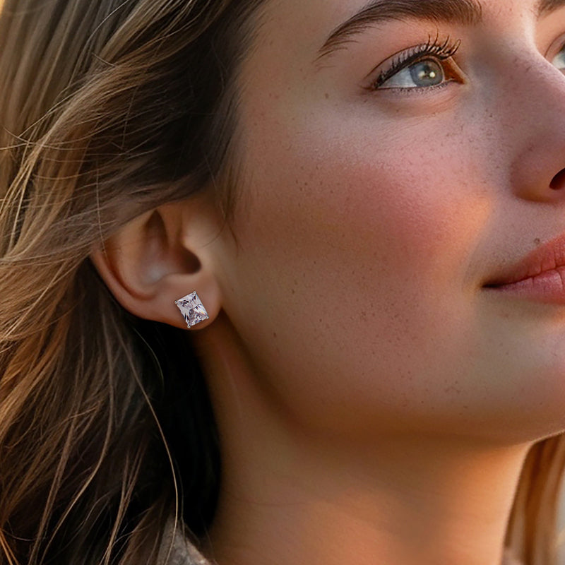 Sterling silver CZ square stud earrings on ear, prong-set clear stone