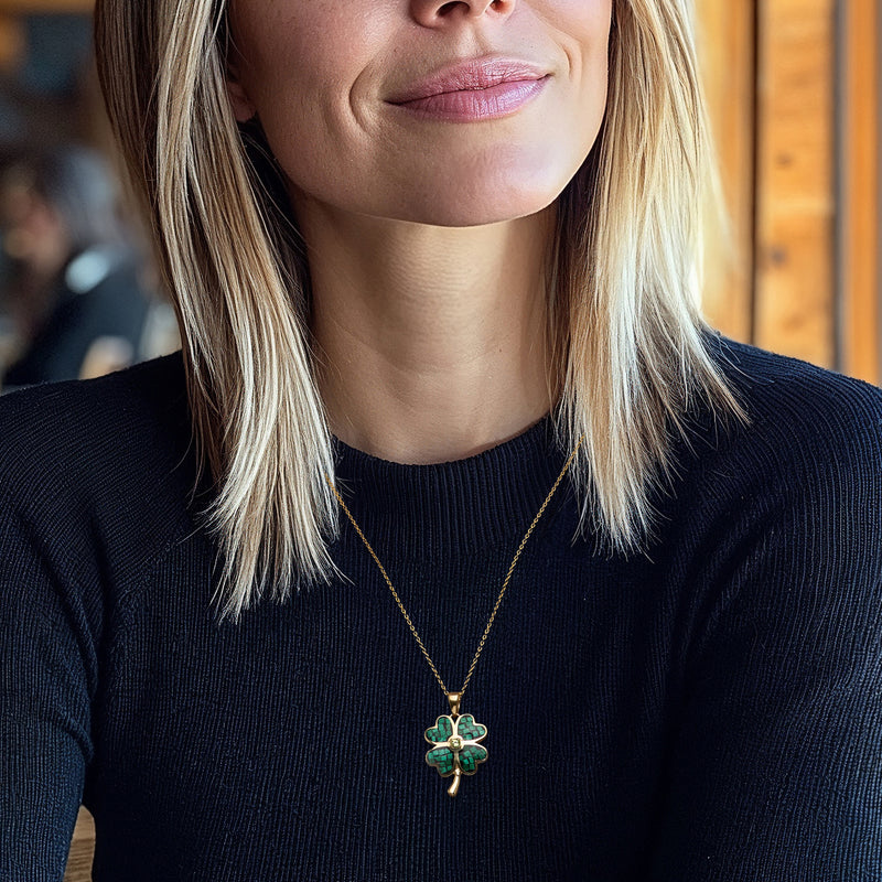 Four-leaf clover pendant necklace worn with gold-tone chain and green clover charm