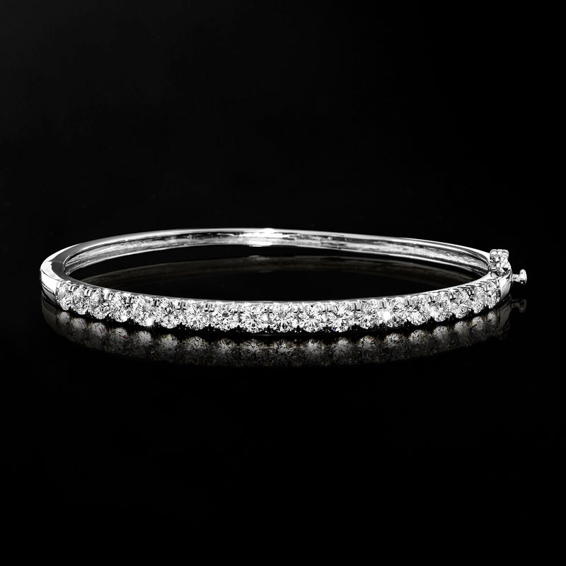 White gold diamond bangle bracelet with row of round stones