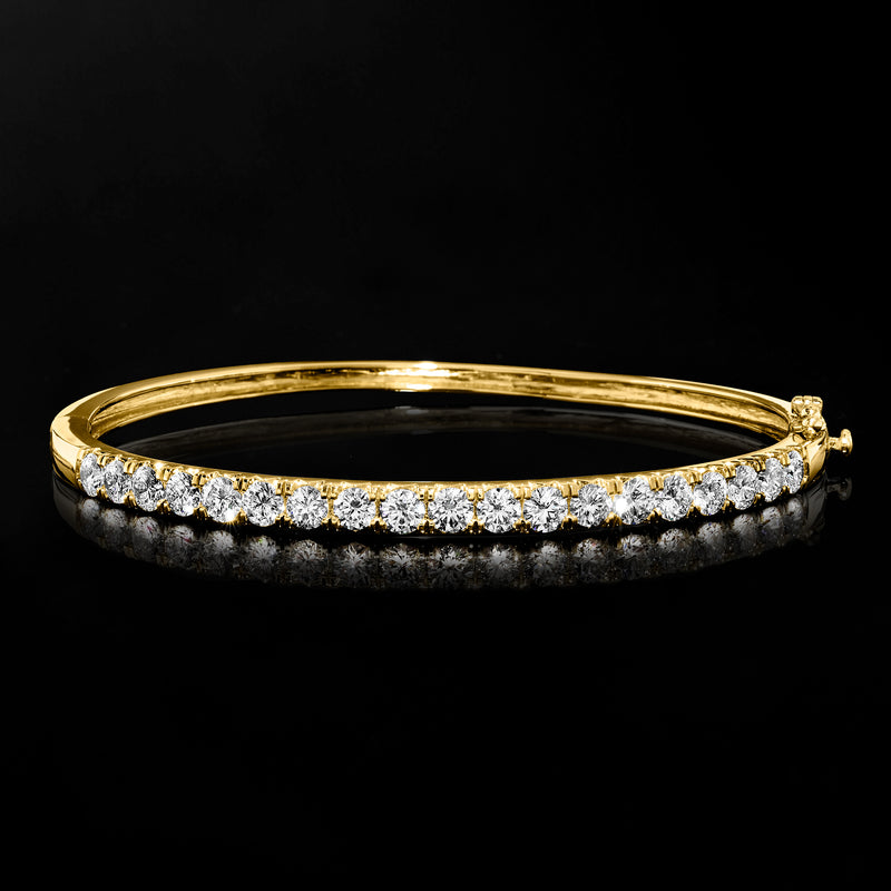 14kt yellow gold bangle bracelet with channel-set round diamonds, slim open profile