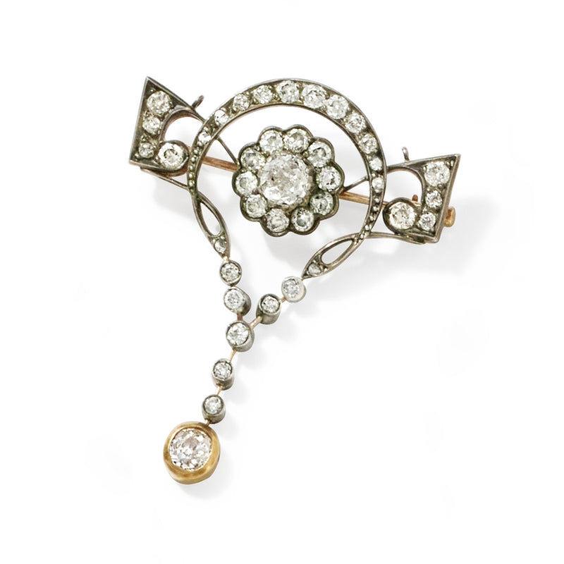 Diamond floral brooch pin in silver with two side bow details and dangling gold bead