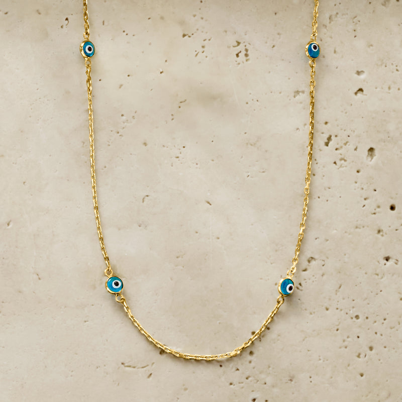 Gold station necklace with multiple blue evil-eye glass beads