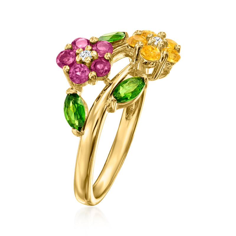 Gold-tone bypass ring featuring purple flower stones and green and yellow gem clusters
