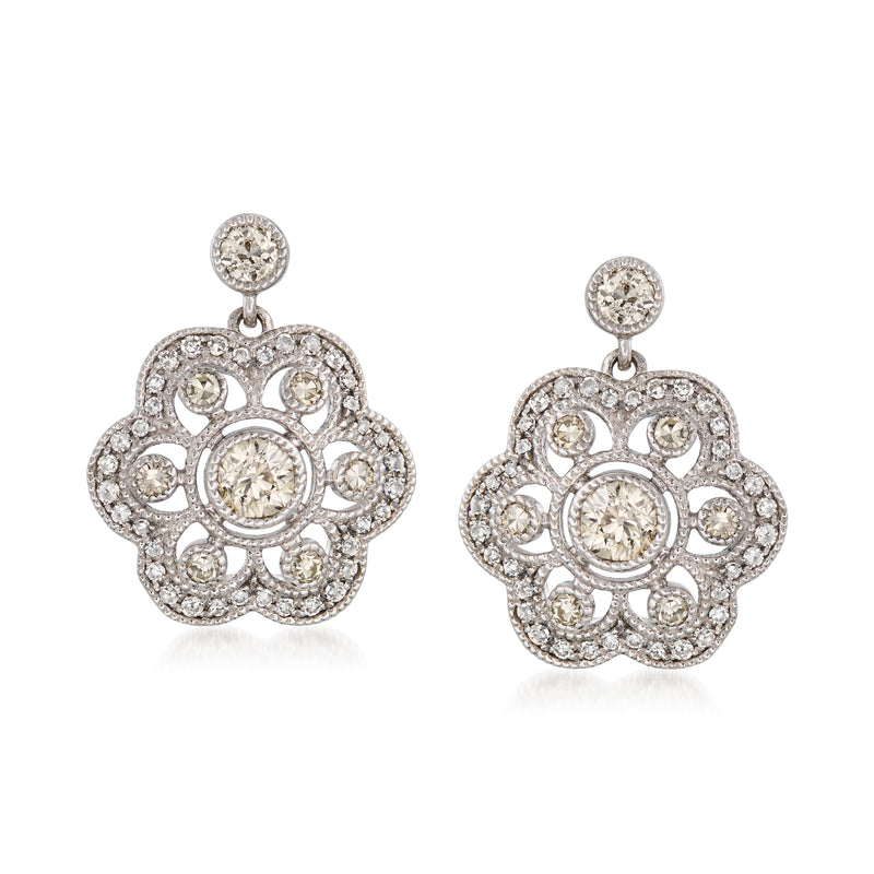 Platinum diamond flower drop earrings with round center stones and halo details