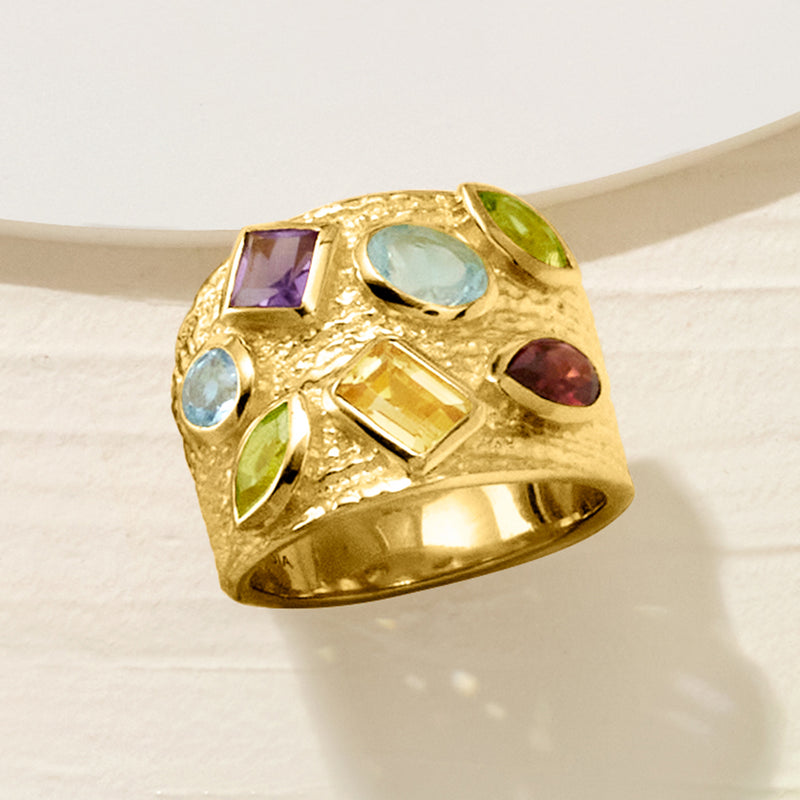 Gold over sterling multi-gem ring, side view with blue oval and green round stones plus purple accents