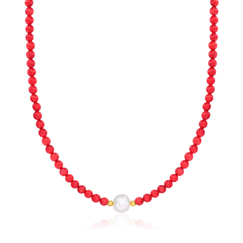 Red coral bead necklace with white pearl and small gold accents, close-up